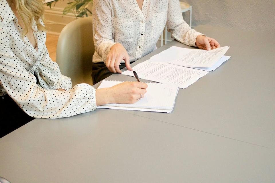 Customer signing documents with an adviser